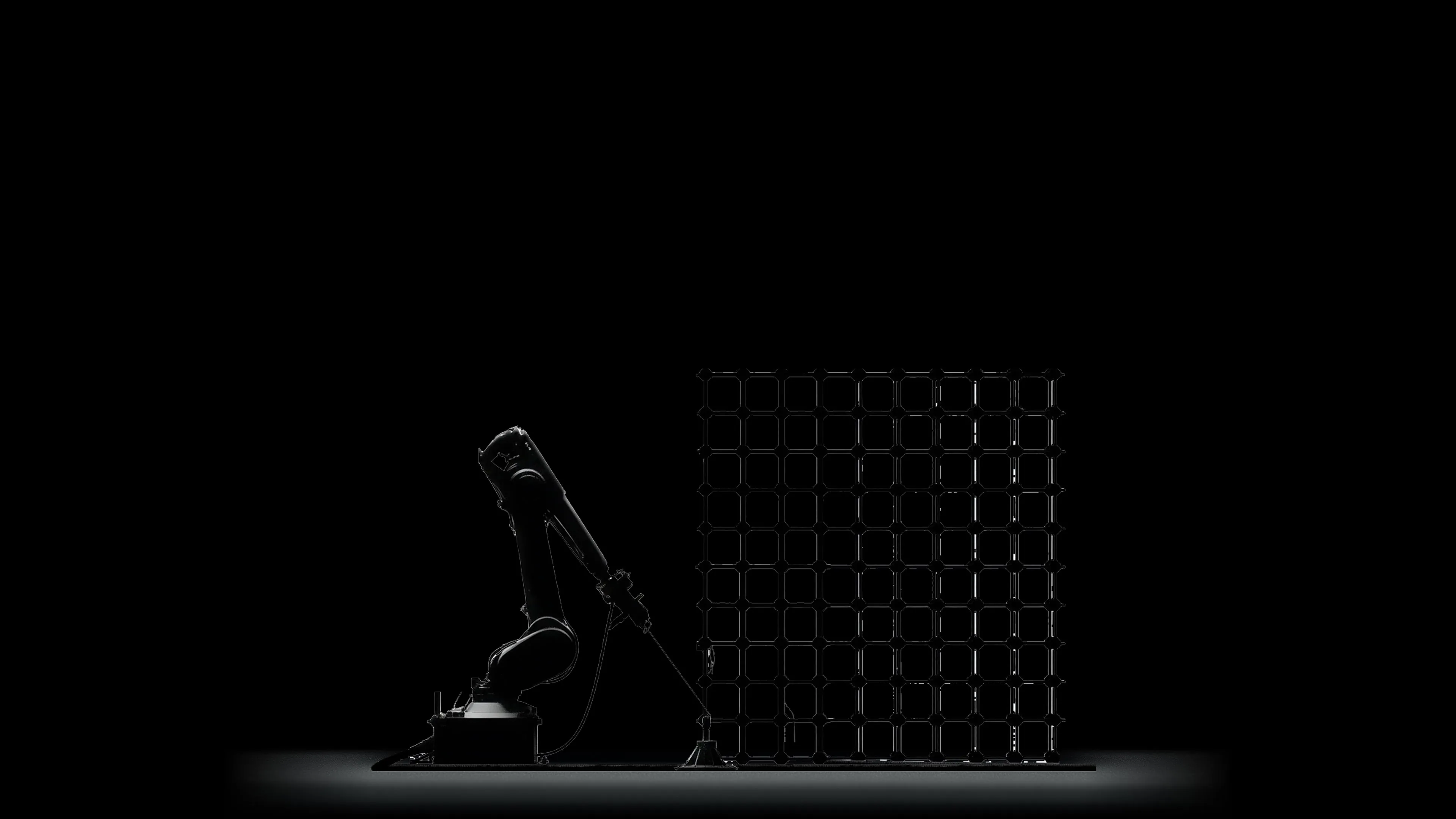 Robot arm beside a wound basalt reinforcement grid on a lit black floor